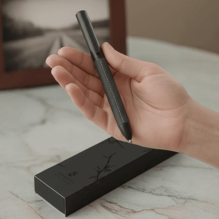 Sengetti Cowskine Ball Pen in hand next to its stylish packaging, perfect for gifting and executive use.