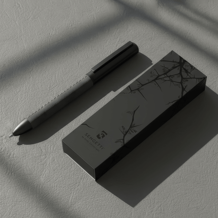 Sengetti Cowskine Ball Pen with its elegant packaging on a textured surface in soft lighting.